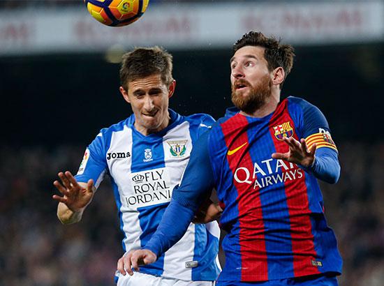 Barcelona's Lionel Messi vies with Leganes' Szymanowski