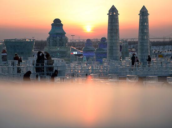 Tourists view ice sculptures at Harbin Ice-Snow World in Harbin, capital of northeast China's