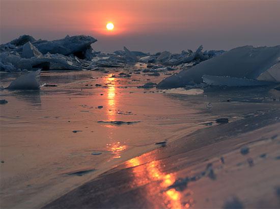 shows ice floe on the Xingkai Lake, border lake between China and Russia