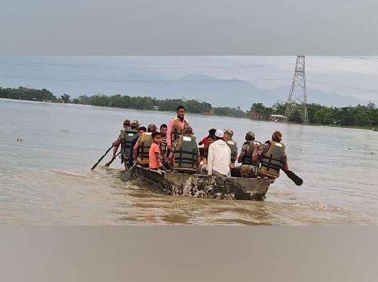 Parents use boats to bring children to primary school surrounded by water in Assam