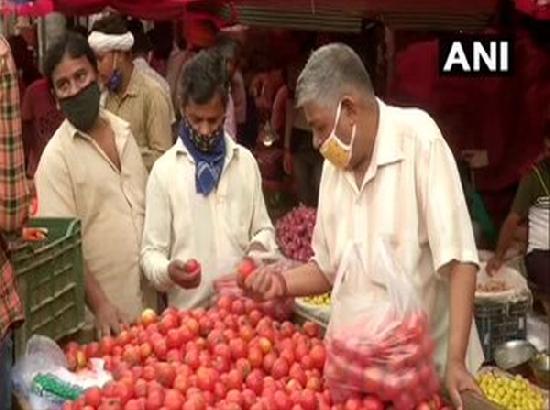 Vendors at Delhi market urge customers to wear masks